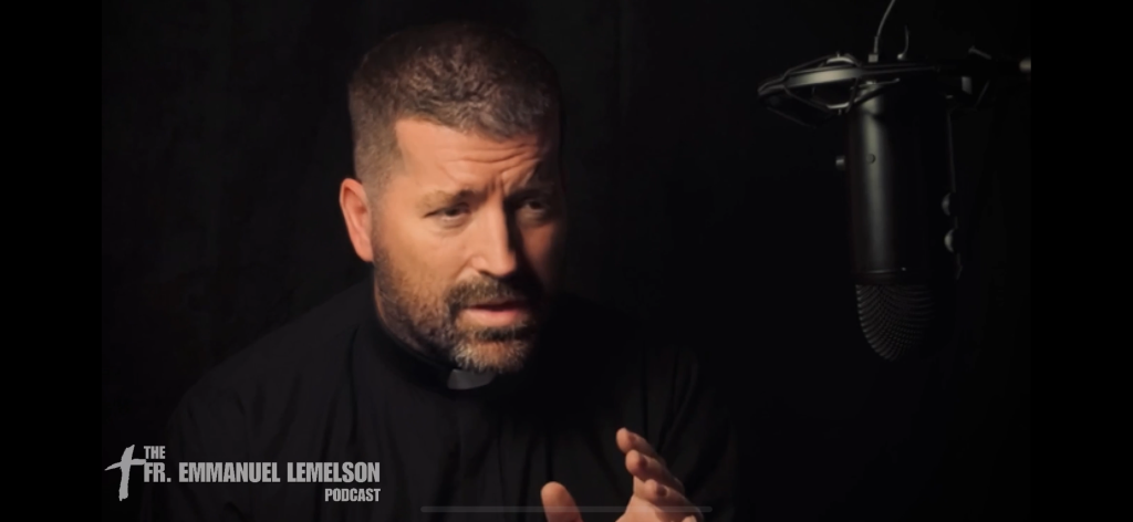 Fr. Emmanuel Lemelson at a microphone